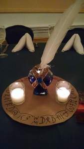 Inkpot and quill centerpieces featuring lines from Raisa's heart-verse.